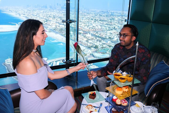 Indulge in a luxurious high tea experience at the iconic Burj Al Arab surrounded by stunning views and exquisite snacks elevating your Dubai visit to new heights.